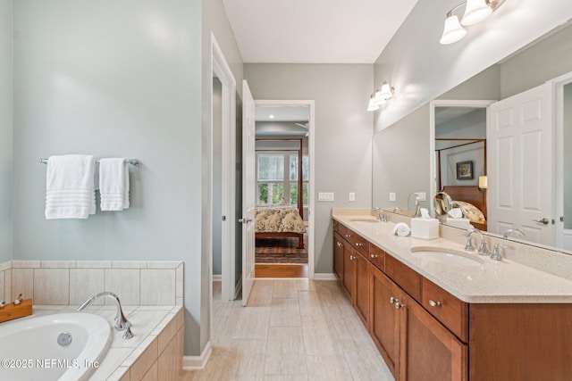 bathroom with vanity and a relaxing tiled tub