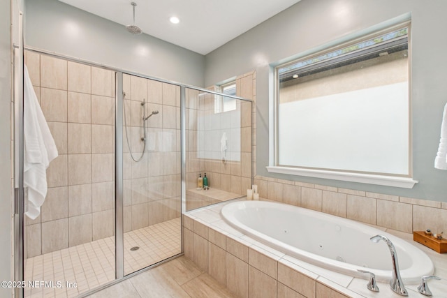 bathroom with tile patterned floors and shower with separate bathtub