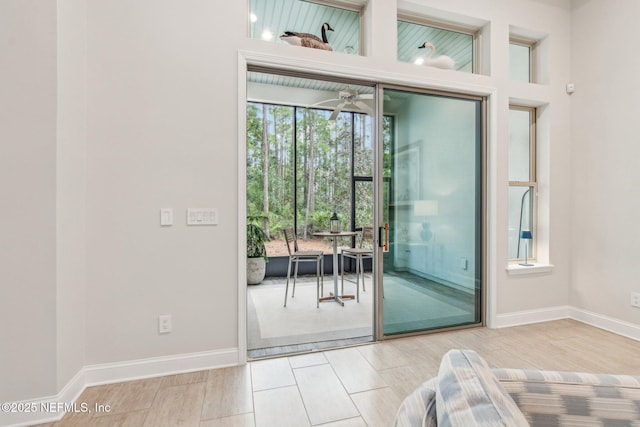 doorway to outside featuring ceiling fan