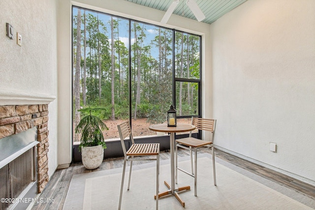 sunroom / solarium featuring a fireplace and wood ceiling