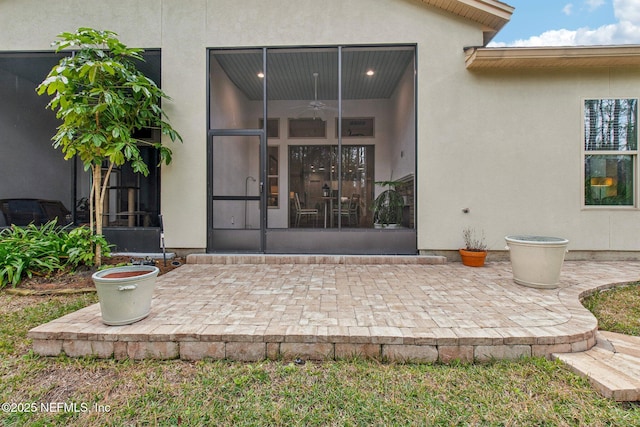 entrance to property with ceiling fan