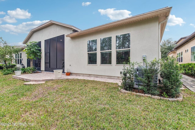 rear view of property with a yard