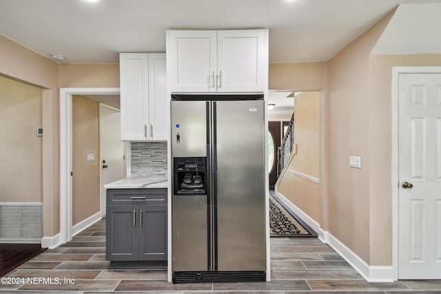 kitchen featuring gray cabinetry, white cabinetry, tasteful backsplash, stainless steel fridge with ice dispenser, and light stone counters