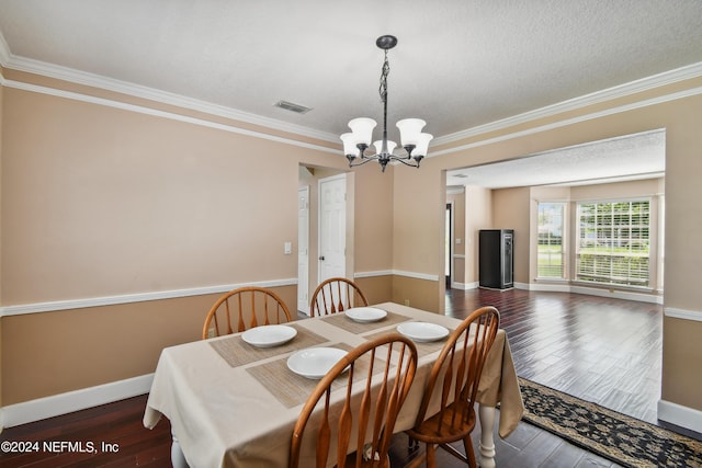 dining space with dark hardwood / wood-style floors, ornamental molding, and a chandelier