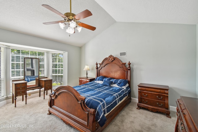 bedroom with ceiling fan, light carpet, and vaulted ceiling