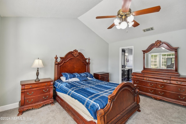 carpeted bedroom featuring ensuite bathroom, ceiling fan, and vaulted ceiling