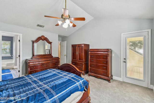 carpeted bedroom with lofted ceiling, connected bathroom, ceiling fan, and multiple windows