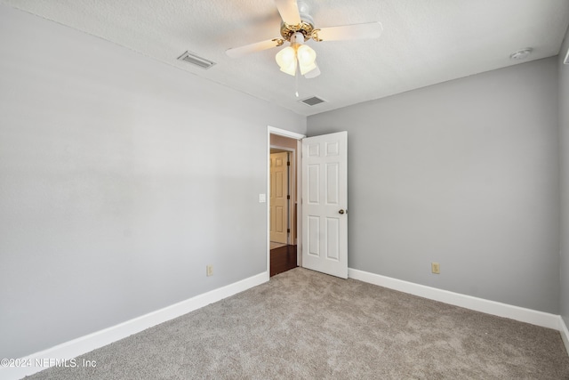 unfurnished room featuring ceiling fan and light colored carpet