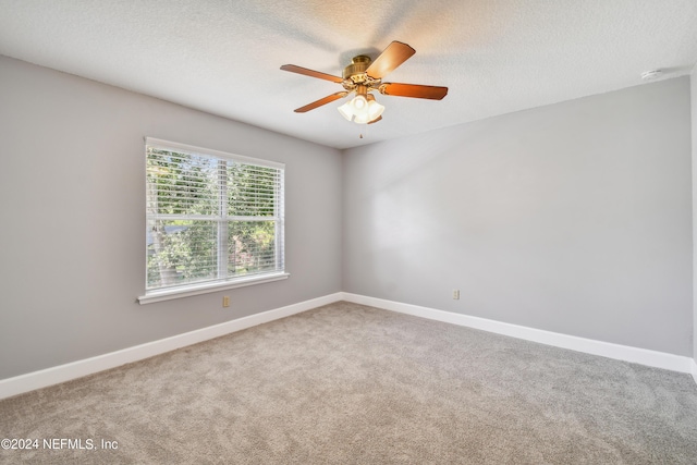 unfurnished room with ceiling fan, carpet floors, and a textured ceiling