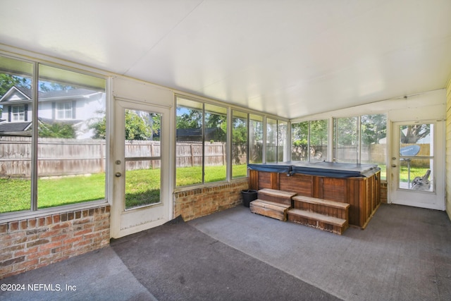 sunroom / solarium featuring a wealth of natural light and a jacuzzi