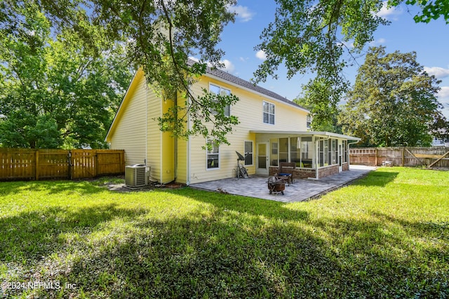 back of house with a yard, a patio, central AC unit, and a sunroom