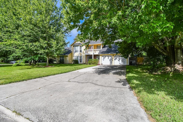 view of front of home with a front yard and a garage