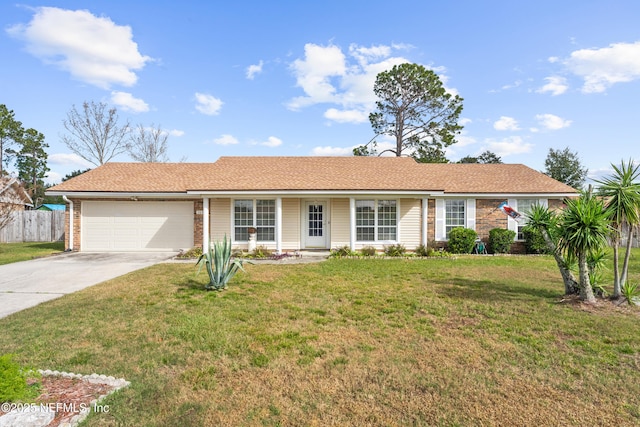 ranch-style home featuring a garage and a front lawn