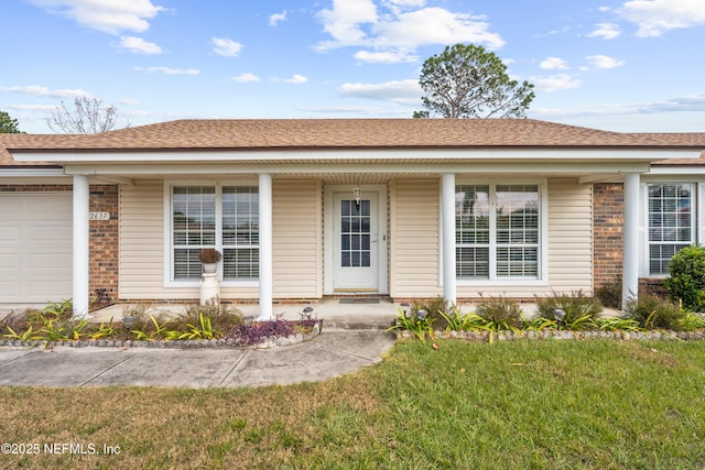 view of front of property with a garage and a front yard