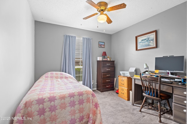 carpeted bedroom featuring a textured ceiling and ceiling fan