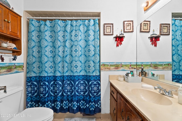 bathroom featuring tile patterned floors, vanity, and toilet