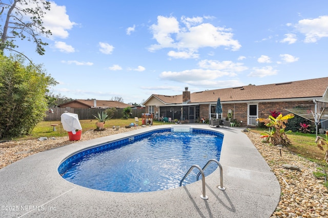 view of pool featuring a sunroom and a patio