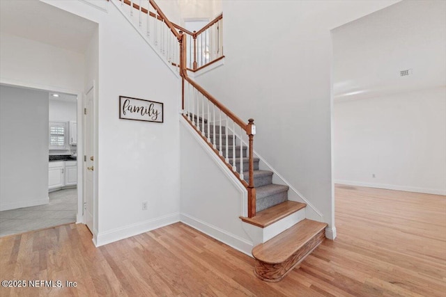 stairs with wood-type flooring