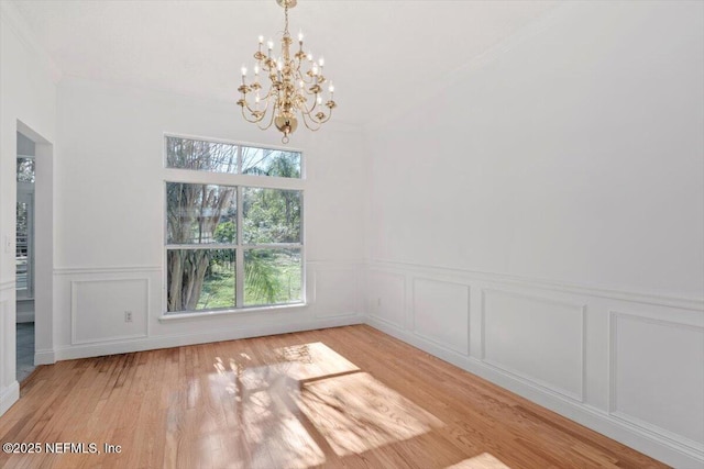 unfurnished dining area with light hardwood / wood-style floors and a notable chandelier