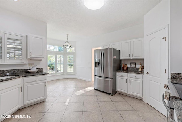 kitchen featuring white cabinets, decorative light fixtures, stainless steel appliances, and a notable chandelier