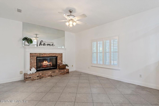 unfurnished living room with a fireplace, ceiling fan, and light tile patterned flooring