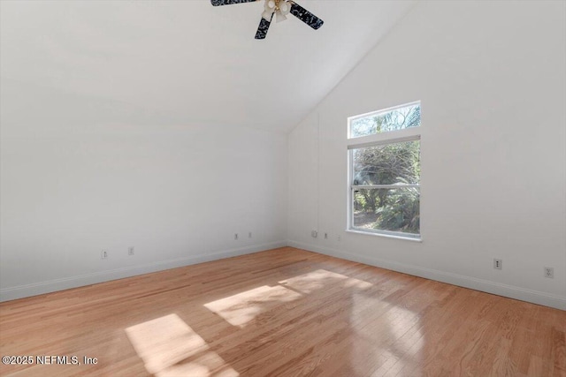 bonus room featuring a towering ceiling, light hardwood / wood-style floors, and ceiling fan