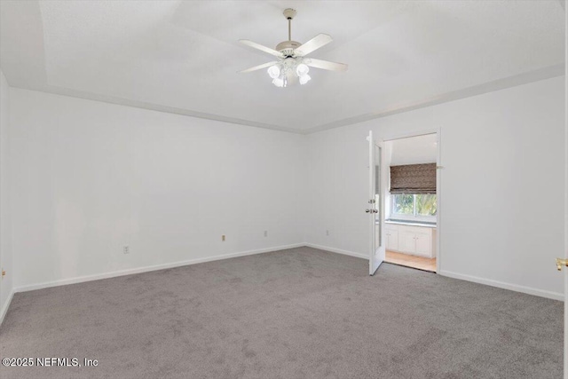 carpeted spare room featuring ceiling fan