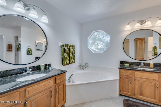 bathroom featuring a washtub, vanity, and tile patterned floors