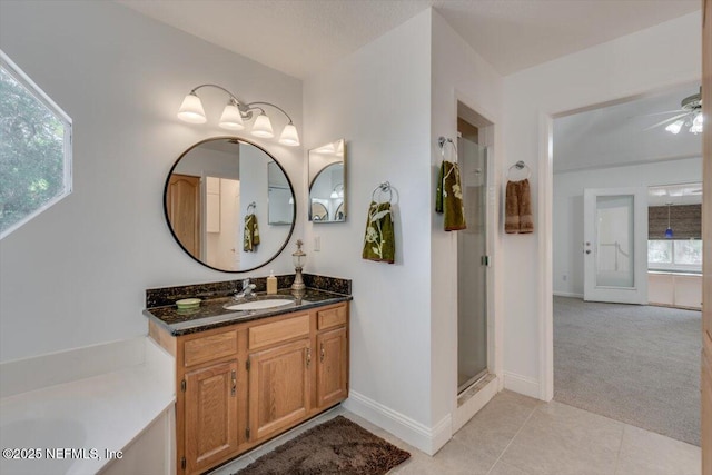 bathroom with tile patterned flooring, vanity, ceiling fan, and a shower with shower door