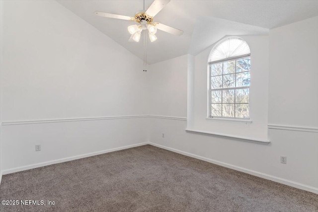 carpeted spare room featuring ceiling fan and lofted ceiling