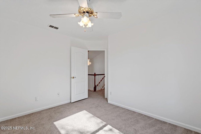 spare room featuring ceiling fan and light colored carpet