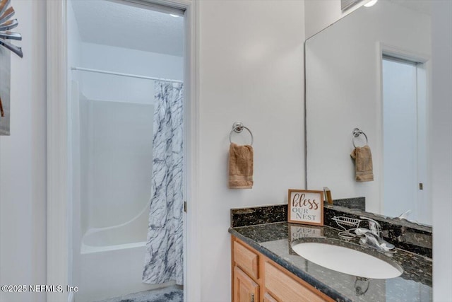 bathroom with shower / bath combo with shower curtain and vanity