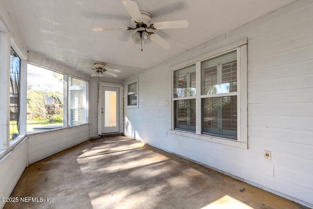 unfurnished sunroom with ceiling fan