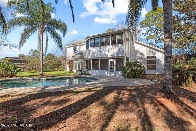 back of house featuring a patio area and a sunroom