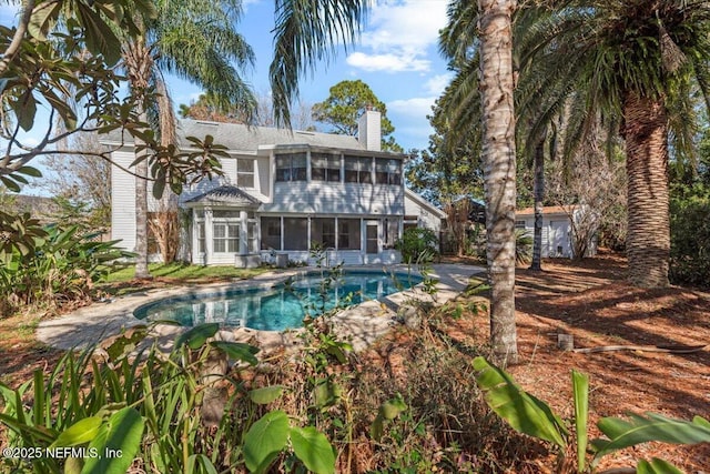 back of house with a sunroom