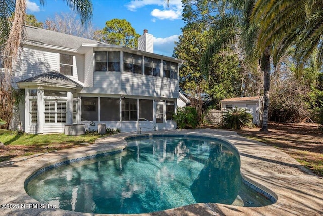 view of swimming pool with a sunroom