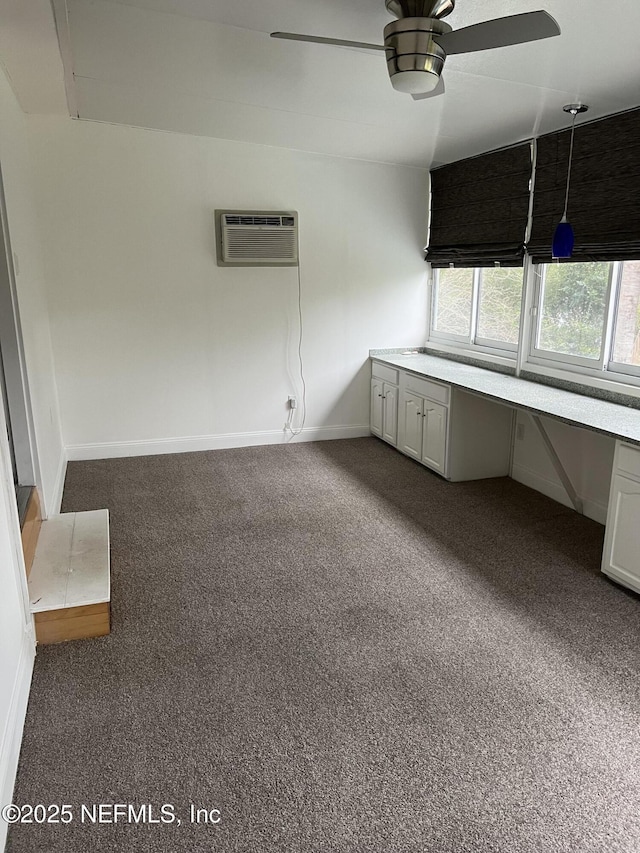 2305 Locustwood Ct, Orange Park, FL 32065 - unfurnished office with an AC wall unit, dark colored carpet, built in study area, and a ceiling fan