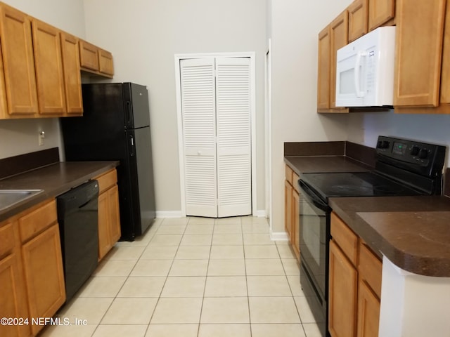 kitchen with light tile patterned floors and black appliances