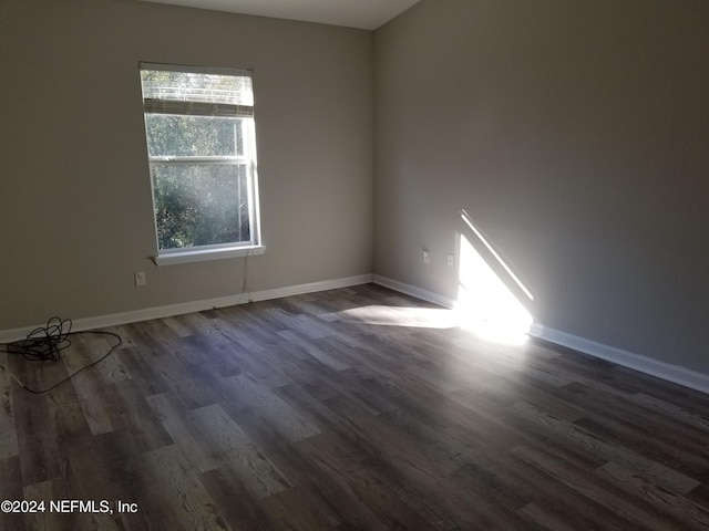 unfurnished room with dark hardwood / wood-style floors