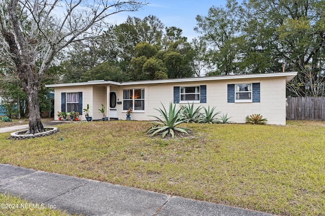 ranch-style house with a front lawn