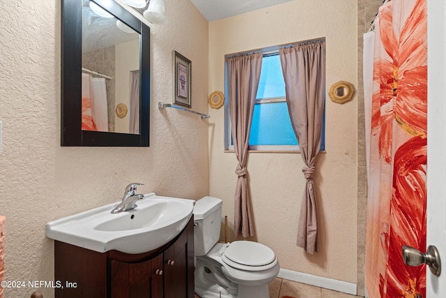 bathroom featuring curtained shower, tile patterned flooring, vanity, and toilet