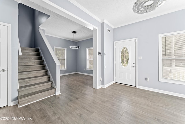 entryway featuring hardwood / wood-style floors, a textured ceiling, and an inviting chandelier