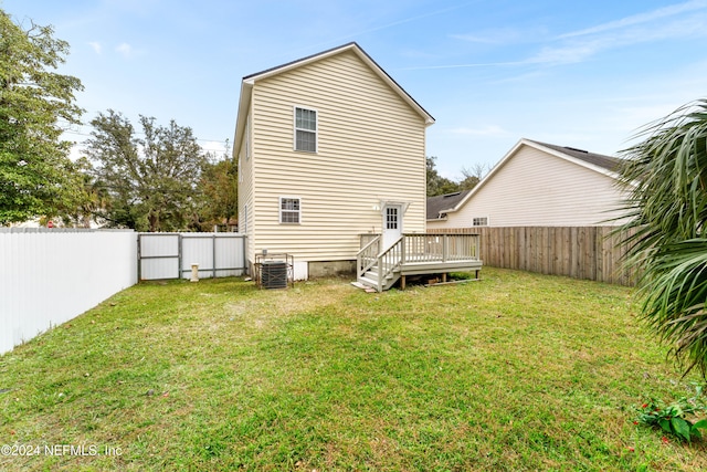 back of house featuring a yard, central AC unit, and a deck