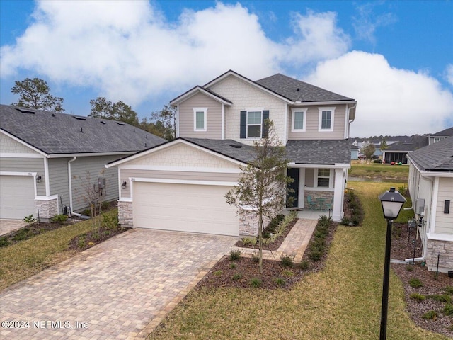 view of front of home with a garage and a front lawn