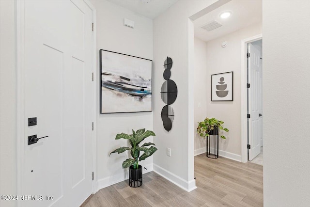 corridor featuring light hardwood / wood-style floors