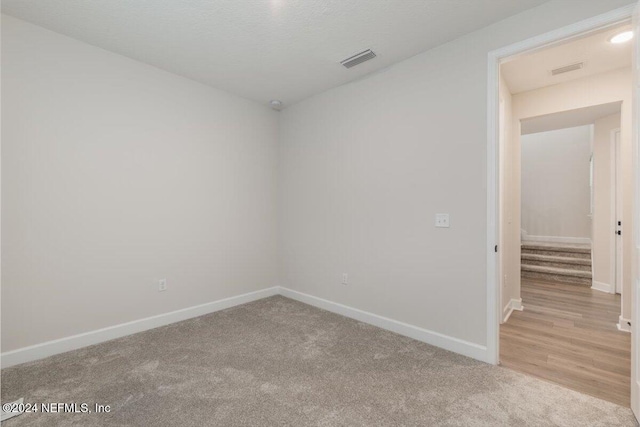 empty room with light colored carpet