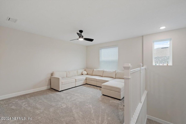 unfurnished living room with ceiling fan and light colored carpet