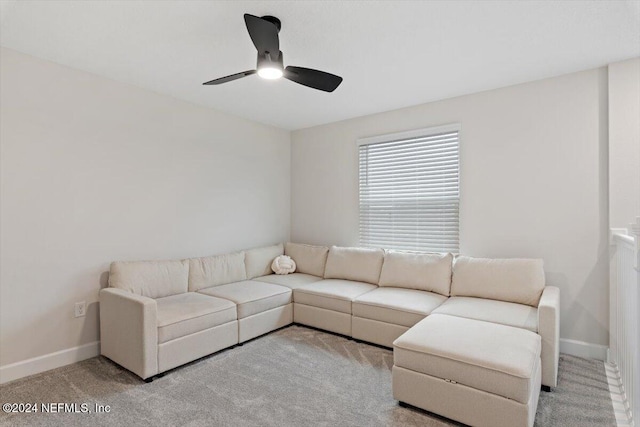 carpeted living room with ceiling fan