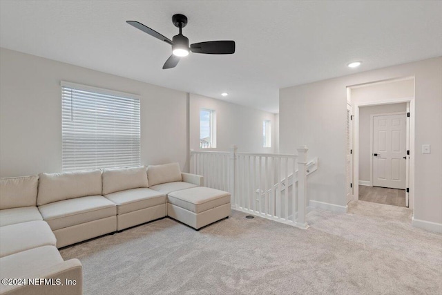 living room with ceiling fan and light colored carpet