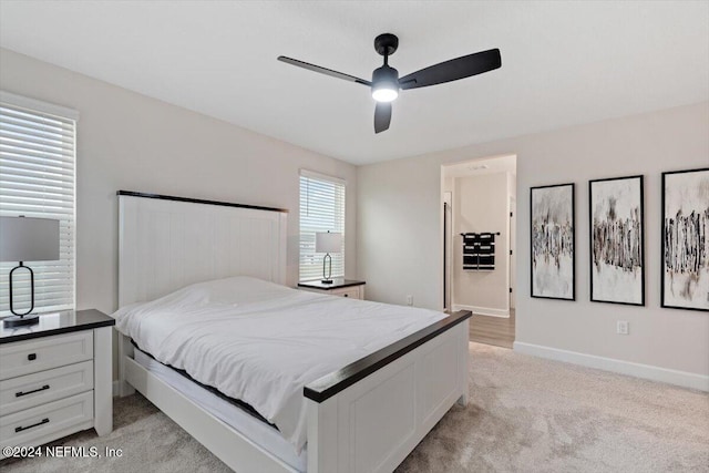 bedroom with ceiling fan and light colored carpet